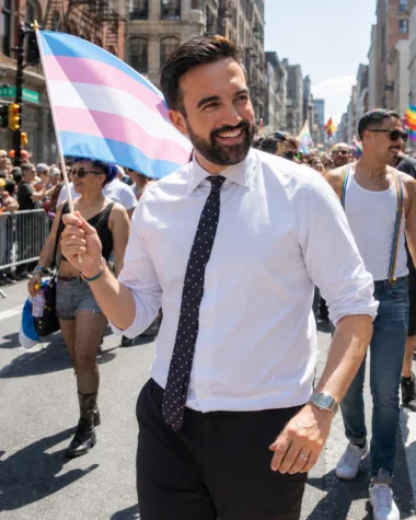 Editorial illustration of Zohran Mamdani carrying a transgender Pride flag at NYC Pride