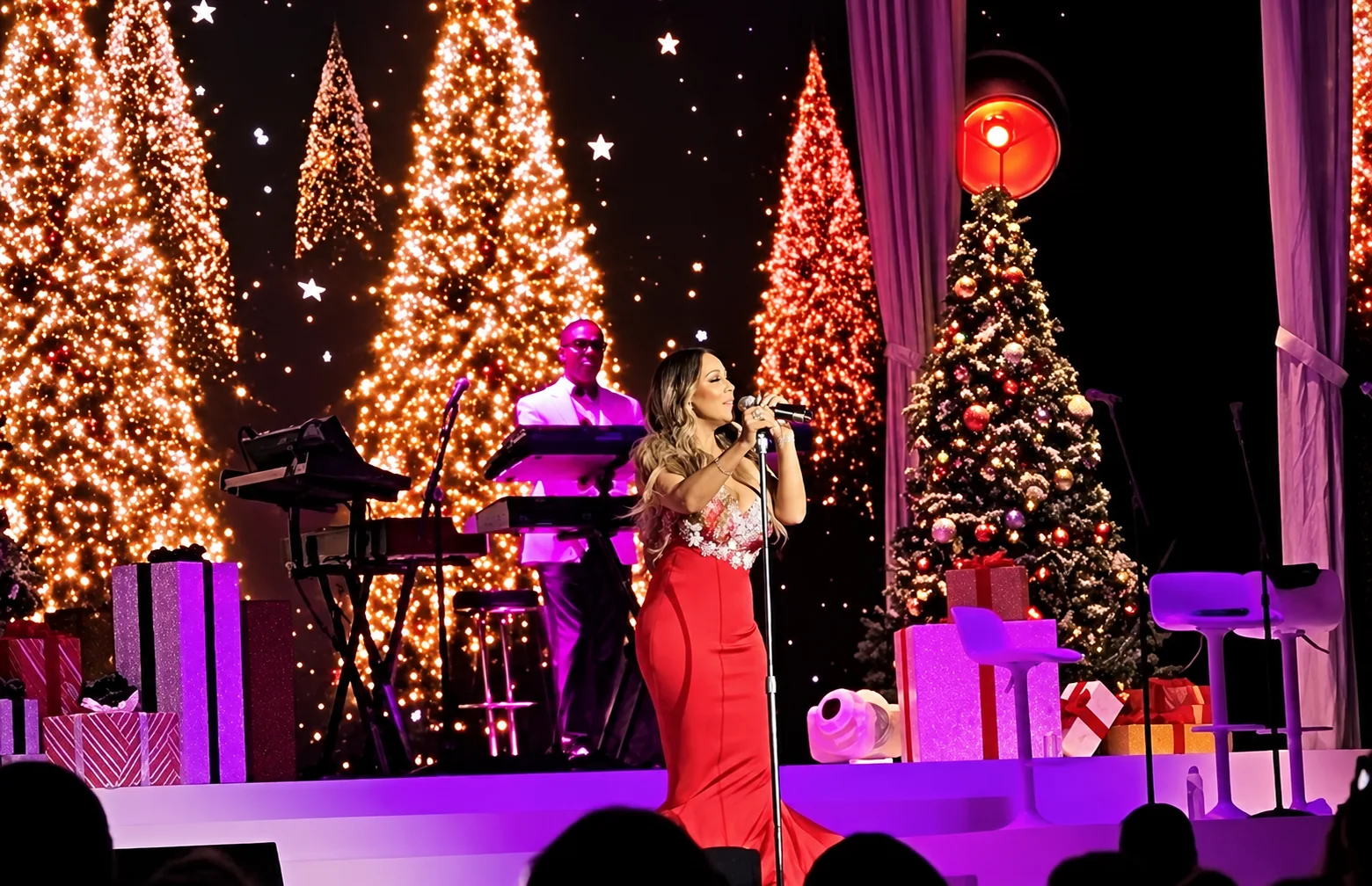 Mariah Carey performing on a Christmas concert stage